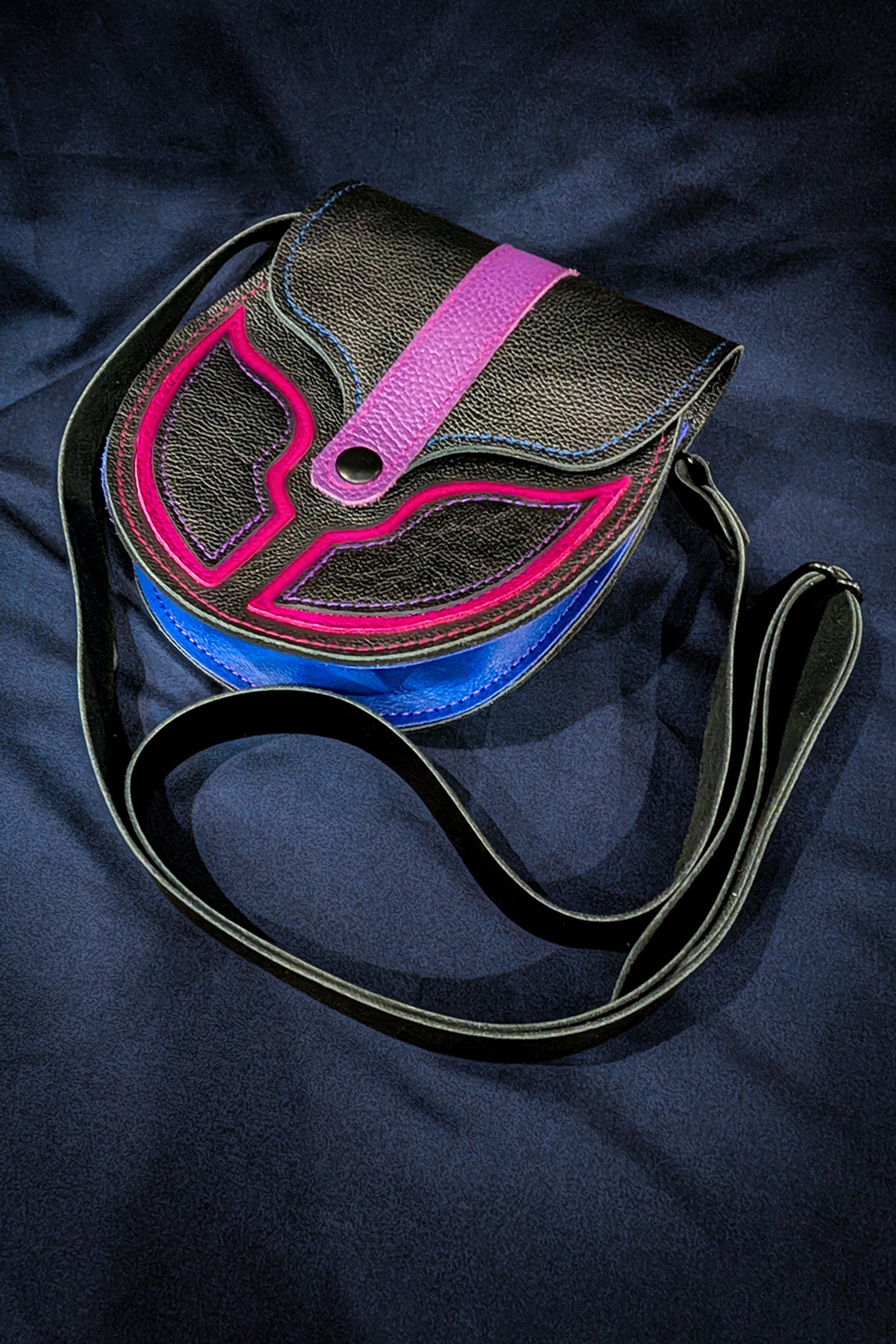 Black leather sporran with dark pink, light pink, and blue details celebrating bi pride.