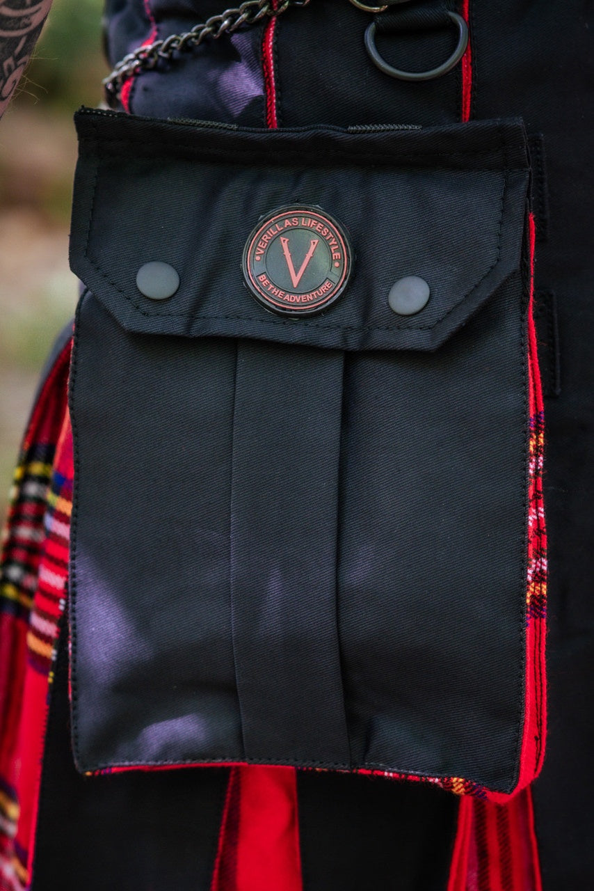 Black pouch with a brand logo attached to a colorful fabric background