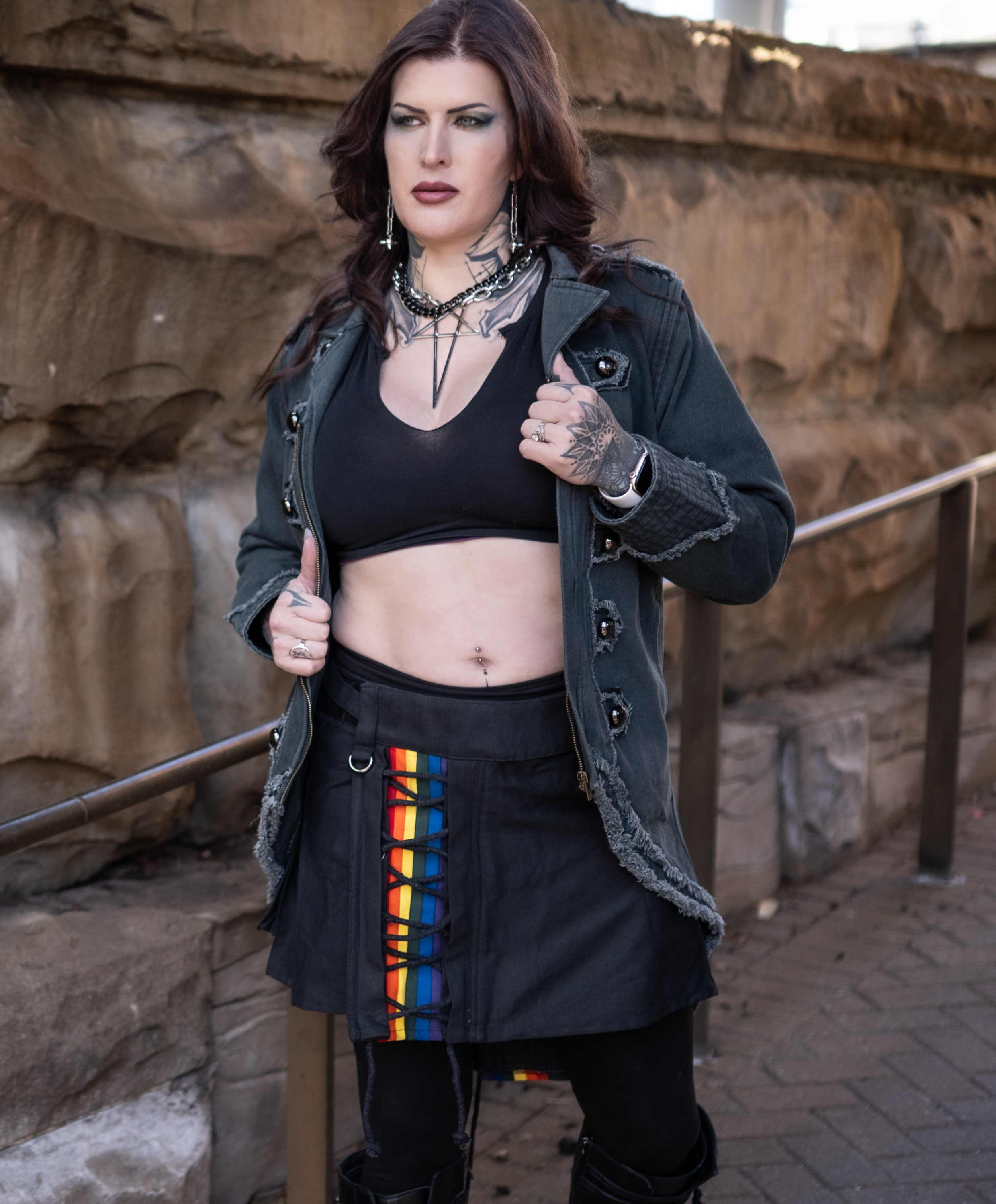 Black kilt featuring a cross-laced panel with rainbow stripes.