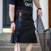 Black 23" kilt featuring a cross-laced section in the front panel with a rainbow stripe.