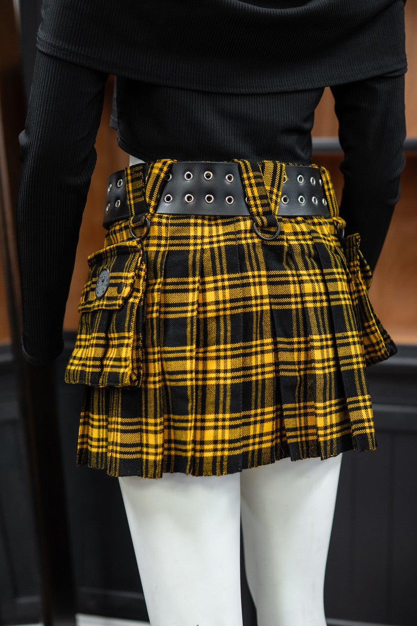 Back view of a yellow plaid mini kilt with a black belt on a mannequin against a blurred background