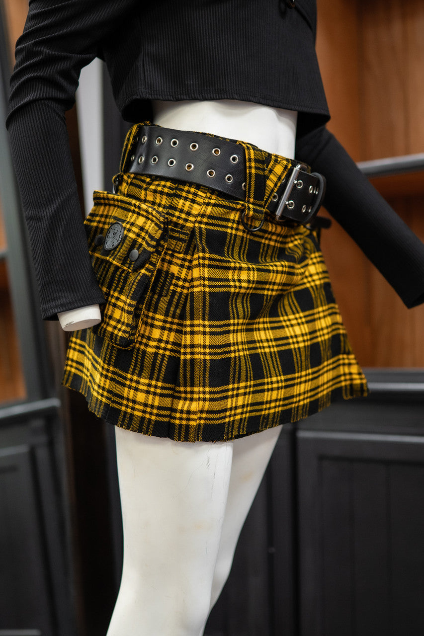 Side view of a mannequin wearing a black and yellow plaid mini kilt showcasing a side pocket.