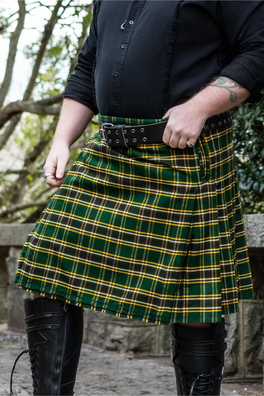 Person wearing a plaid kilt with a black belt