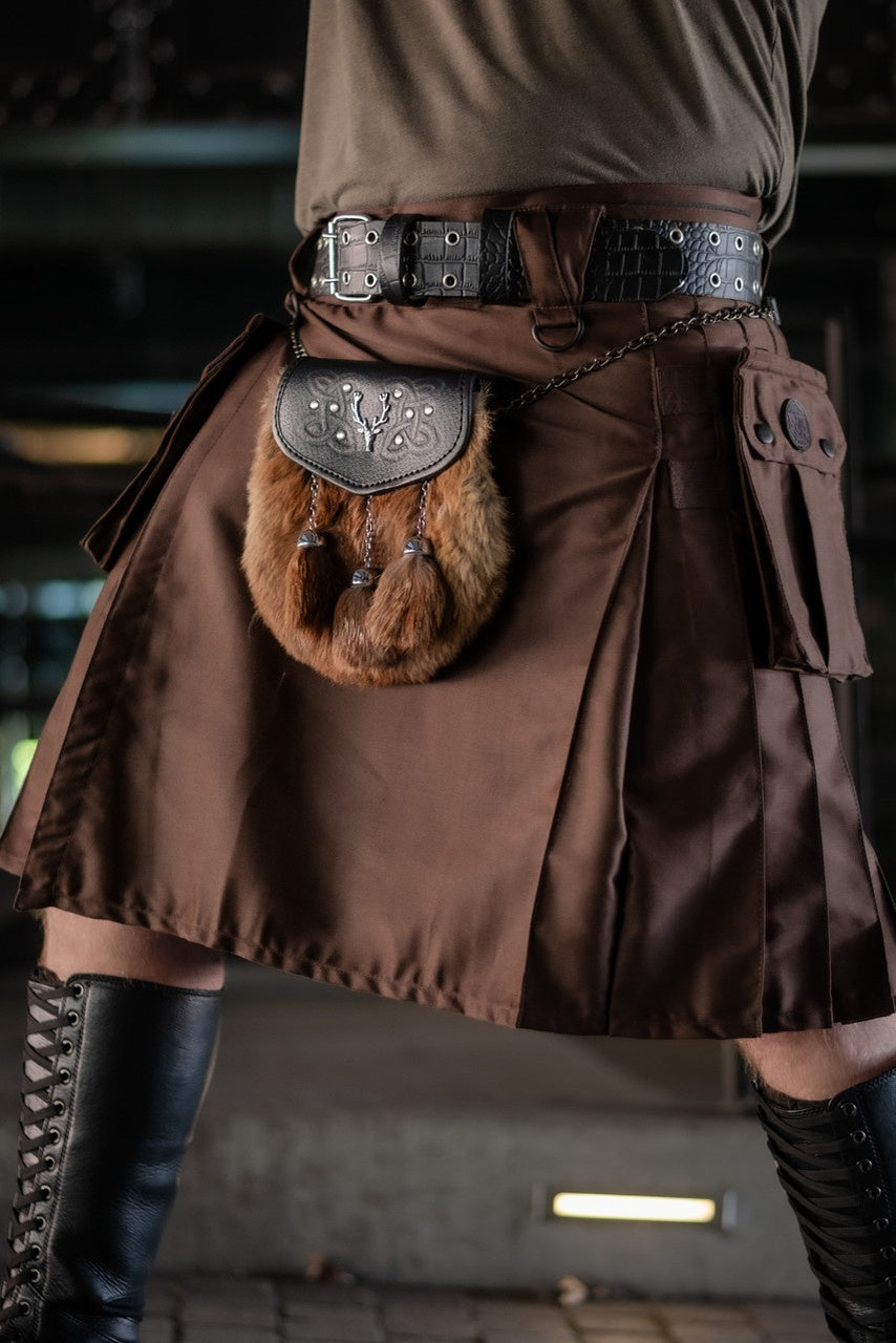 Brown kilt with a fur pouch and belt worn by a person, blurred background