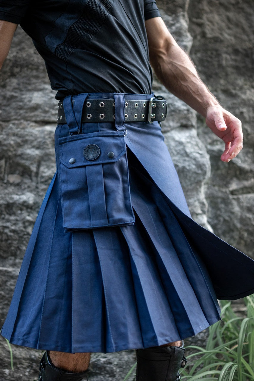 Person wearing a blue kilt with a stone wall background