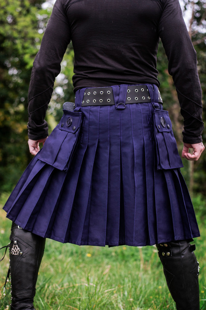 Person wearing a navy blue kilt with a belt, standing outdoors.