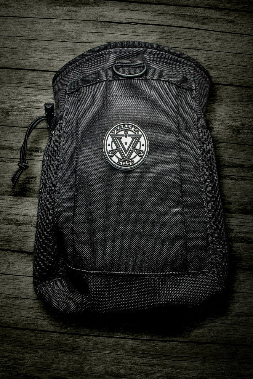 Black pouch with a Versatta logo on a wooden surface