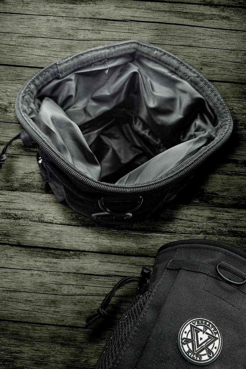 Black bag with a visible brand logo on a wooden surface
