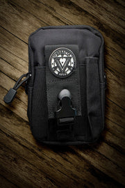 Black tactical pouch with a logo on a wooden surface
