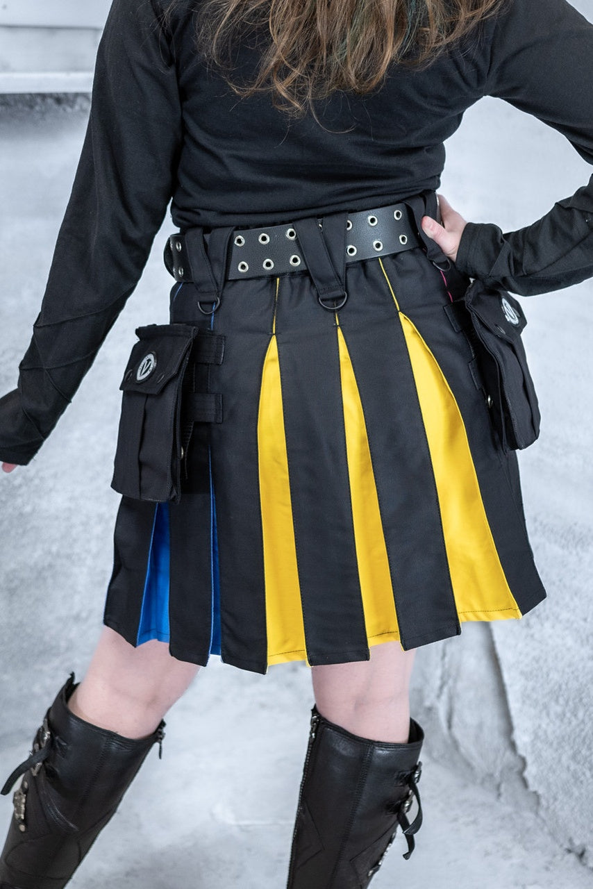 Person wearing a black and yellow striped skirt with tactical pouches in a snowy setting