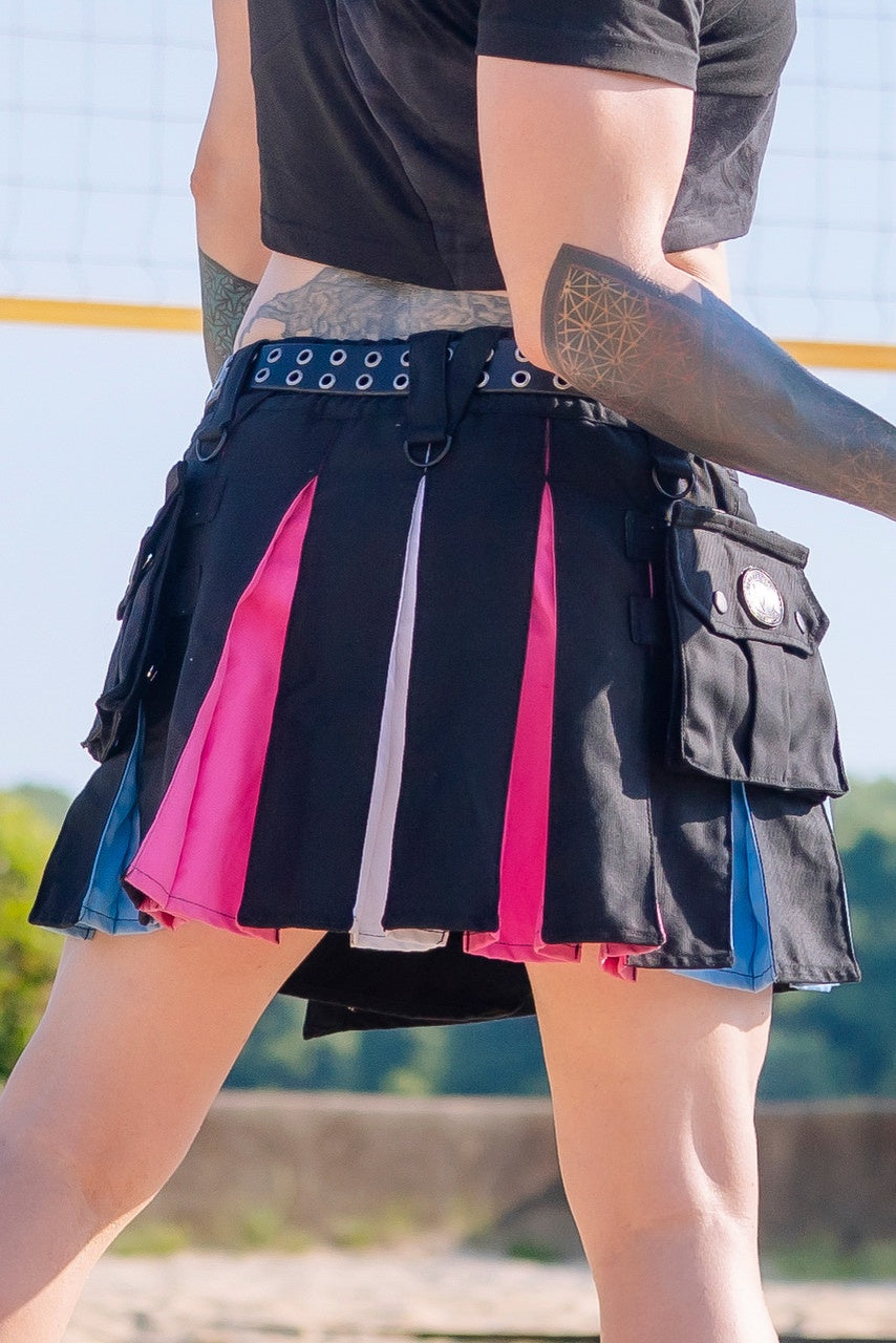 Close up back view of a person in a black and trans pride-themed mini kilt with a black leather belt.