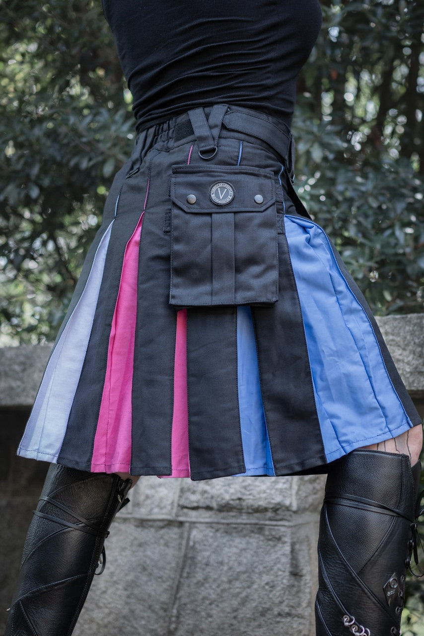 Close up of a person wearing a black kilt with blue, pink, and white side panels for trans pride. 